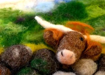 A photo of a needle felt highland cow.